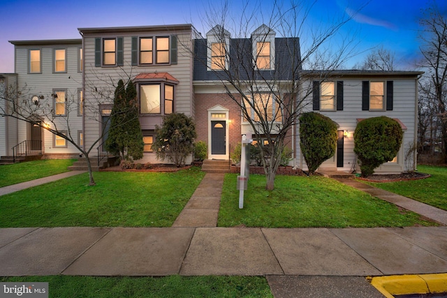 view of property featuring a lawn