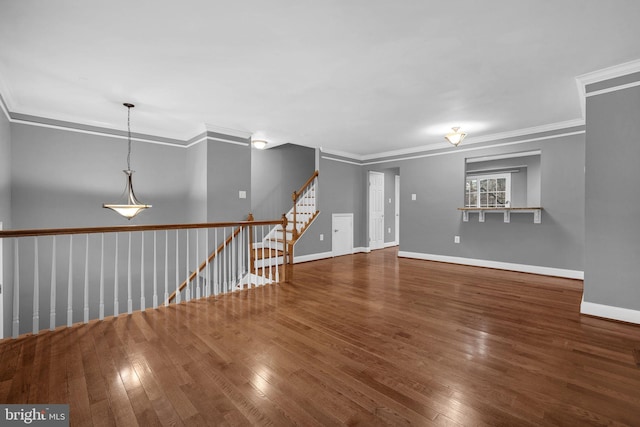 empty room featuring ornamental molding and dark hardwood / wood-style floors