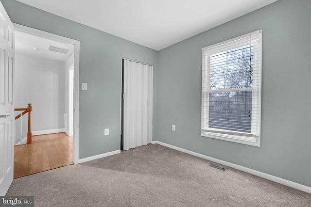 unfurnished bedroom featuring carpet floors and a closet