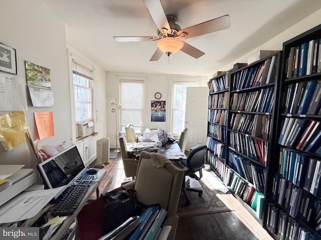 miscellaneous room with hardwood / wood-style flooring, radiator heating unit, and ceiling fan