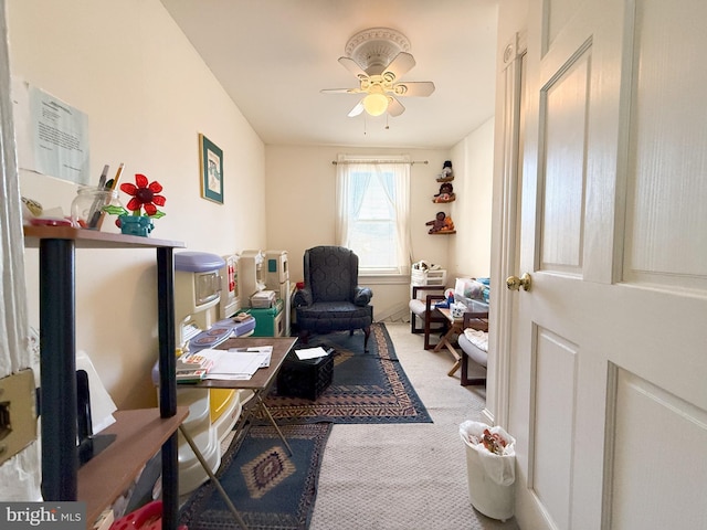 sitting room featuring carpet and ceiling fan