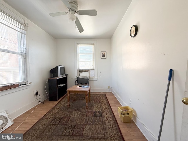 home office featuring cooling unit, hardwood / wood-style floors, and ceiling fan