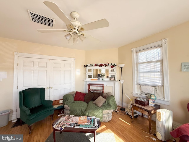 living room with hardwood / wood-style flooring and ceiling fan