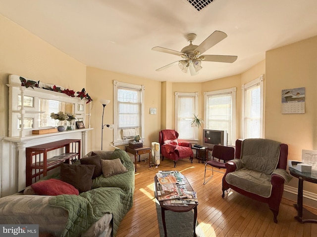 living room featuring ceiling fan and light hardwood / wood-style flooring