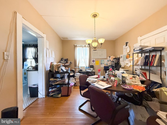 home office with hardwood / wood-style floors and a chandelier