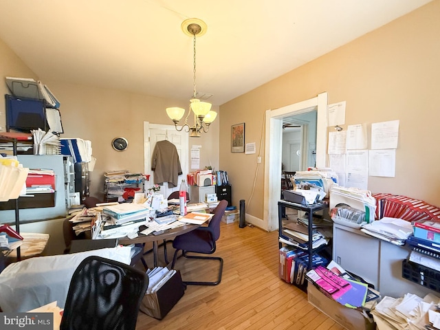 home office with an inviting chandelier and light wood-type flooring