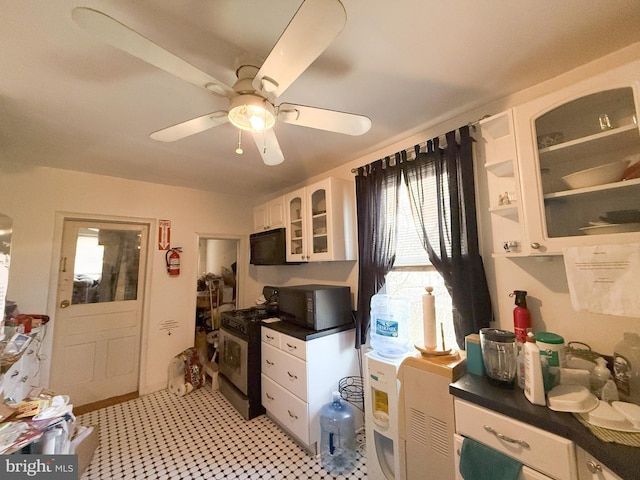 kitchen featuring white cabinetry, ceiling fan, and stainless steel range with gas cooktop