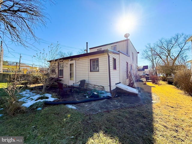 view of side of property with a lawn