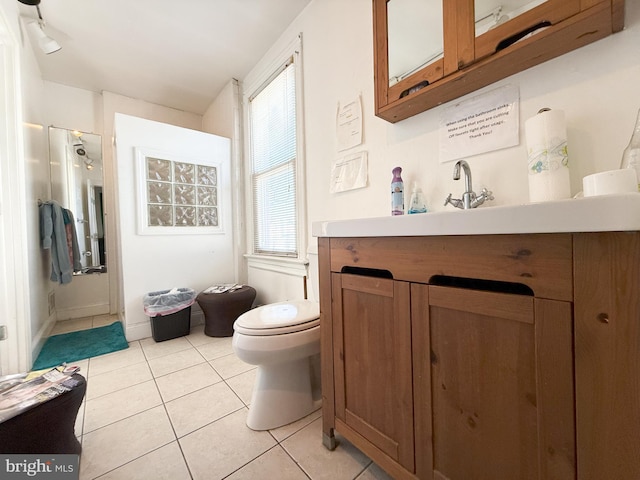 bathroom featuring vanity, toilet, and tile patterned flooring