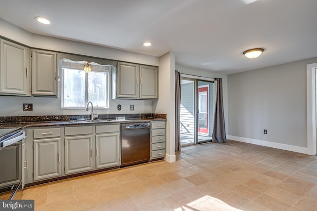 kitchen featuring gray cabinets, dishwasher, sink, dark stone countertops, and stove