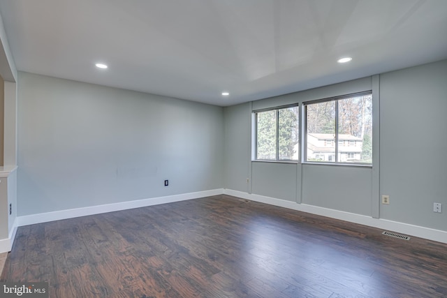 empty room with dark hardwood / wood-style floors