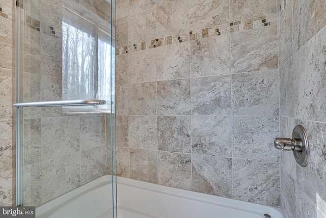 bathroom featuring bath / shower combo with glass door