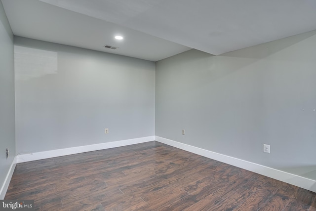 spare room featuring dark hardwood / wood-style floors