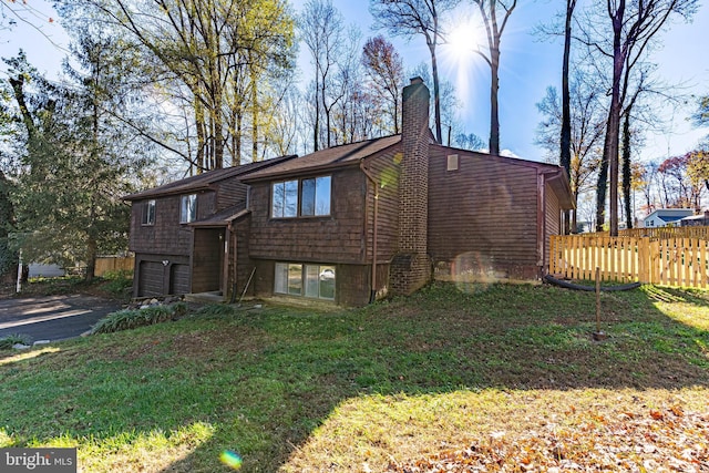 exterior space with a garage and a yard