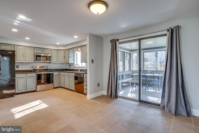 kitchen featuring sink, gray cabinets, black appliances, and light tile patterned flooring