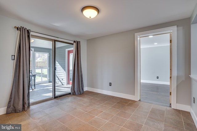 spare room featuring light tile patterned flooring