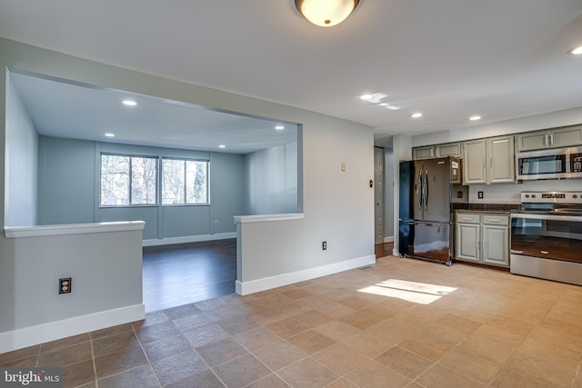 kitchen with appliances with stainless steel finishes and gray cabinets