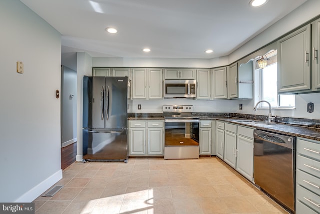 kitchen featuring gray cabinets, sink, light tile patterned floors, and black appliances