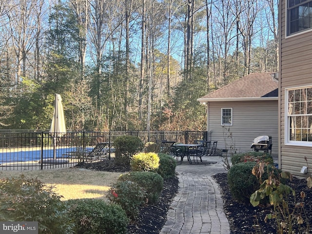 view of yard featuring a patio and a covered pool