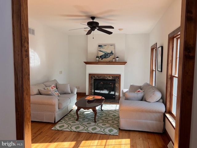 living room featuring ceiling fan and light hardwood / wood-style floors