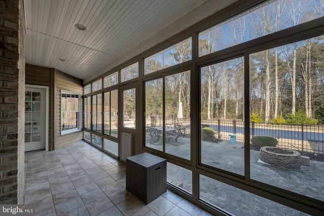 unfurnished sunroom featuring wooden ceiling