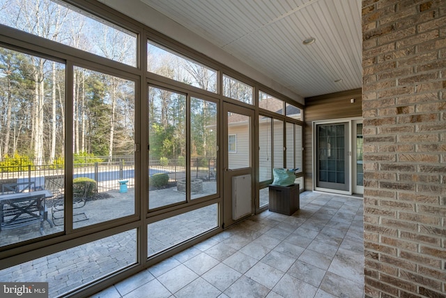 unfurnished sunroom featuring wooden ceiling