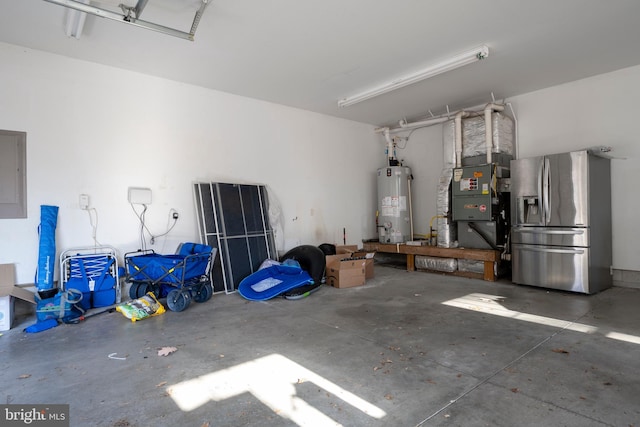 garage featuring electric panel, stainless steel fridge with ice dispenser, and water heater