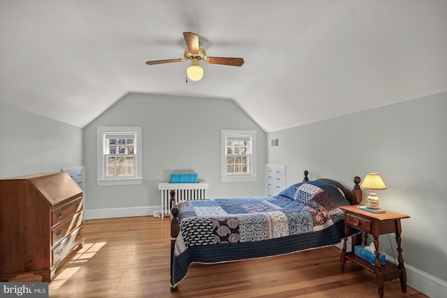 bedroom featuring ceiling fan, lofted ceiling, and light hardwood / wood-style floors