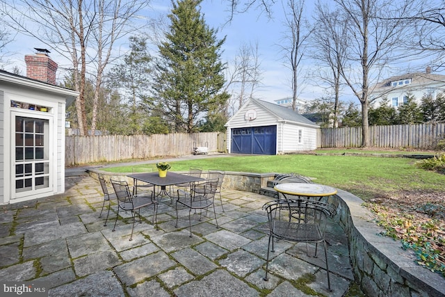 view of patio / terrace with a garage and a shed