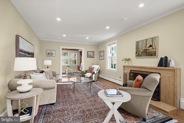 living room featuring ornamental molding, a wealth of natural light, and baseboard heating