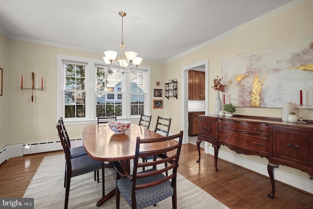 dining area featuring crown molding, a chandelier, and hardwood / wood-style floors