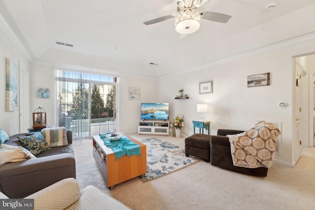 carpeted living room featuring crown molding and ceiling fan