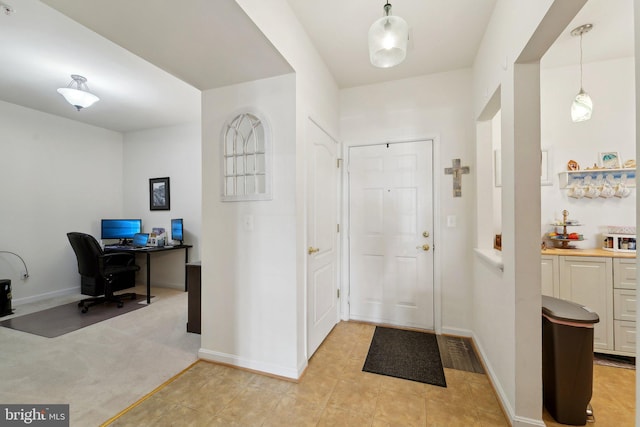 view of carpeted foyer entrance