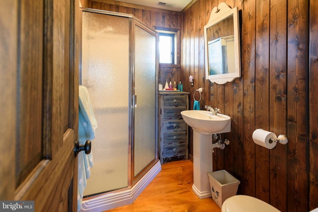 1308 Town Point Rd, Cambridge, MD 21613 - bathroom featuring hardwood / wood-style flooring, sink, an enclosed shower, and wooden walls