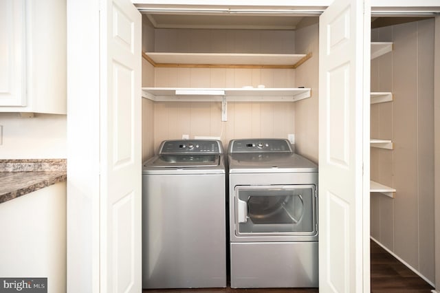 laundry area with washing machine and dryer and dark hardwood / wood-style floors