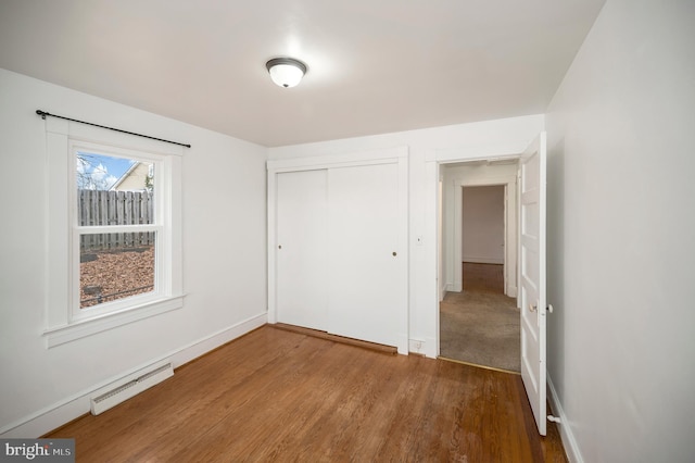 unfurnished bedroom featuring hardwood / wood-style floors and a closet