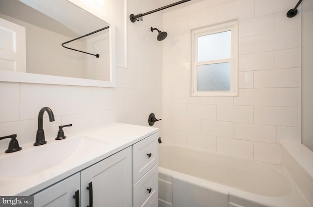 bathroom with vanity, tile walls, backsplash, and tiled shower / bath