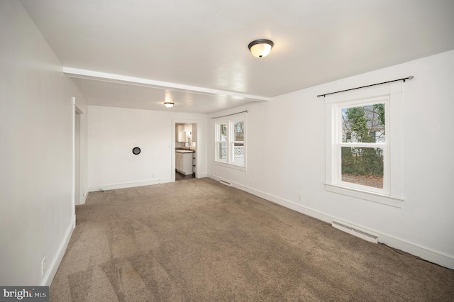 carpeted spare room with sink