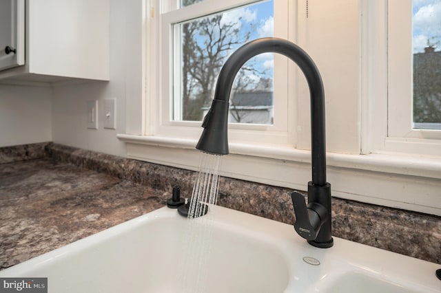 room details with white cabinetry and sink