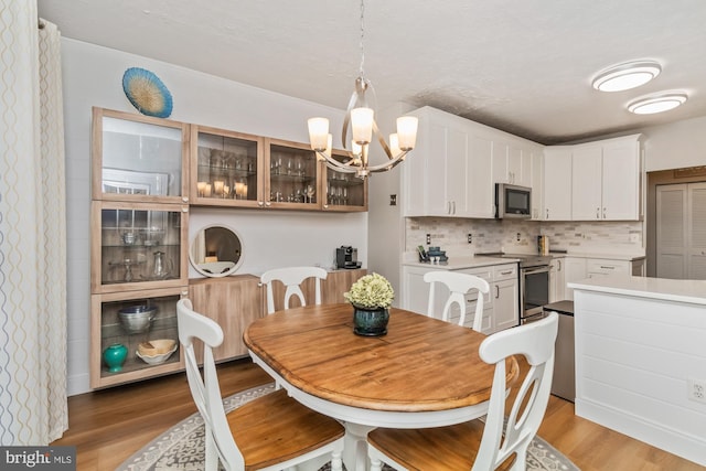 dining room featuring a notable chandelier and light hardwood / wood-style floors