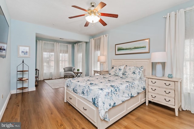 bedroom with light hardwood / wood-style flooring and ceiling fan