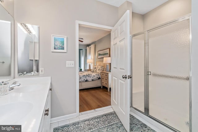 bathroom with walk in shower, tile patterned floors, and vanity