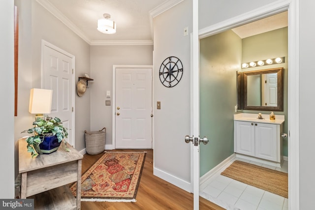 entryway featuring ornamental molding and hardwood / wood-style floors