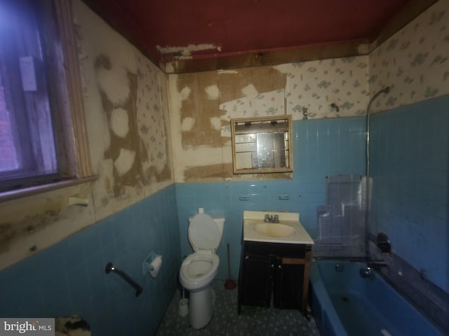 full bathroom featuring shower / bath combination, tile walls, vanity, tile patterned floors, and toilet