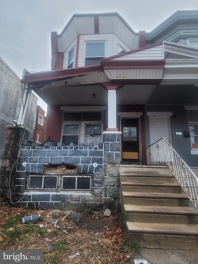 view of exterior entry featuring a porch