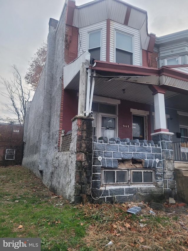 view of property exterior with a porch