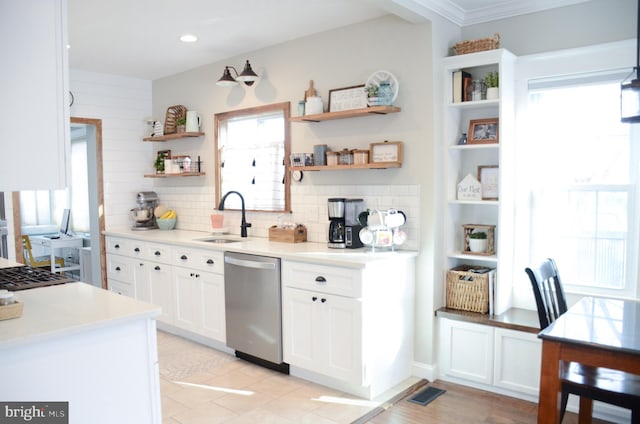 kitchen with white cabinetry, stainless steel appliances, sink, and tasteful backsplash