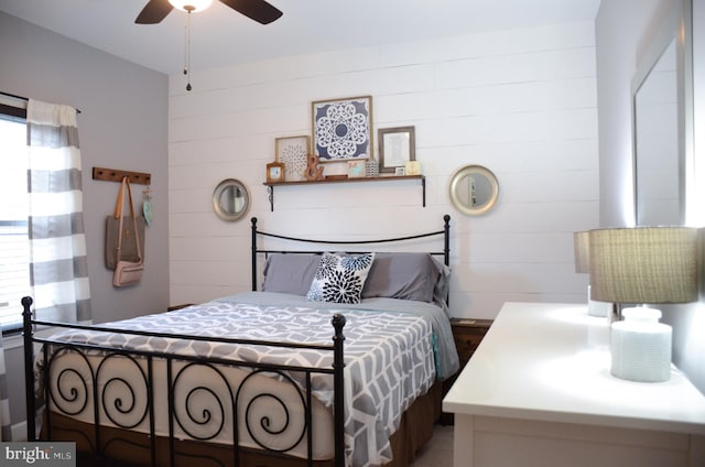 bedroom featuring ceiling fan and multiple windows