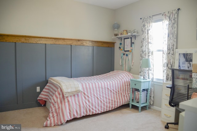 carpeted bedroom featuring multiple windows