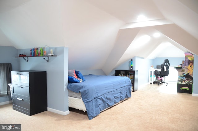 carpeted bedroom featuring vaulted ceiling